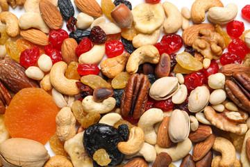 Different dried fruits and nuts as background, closeup