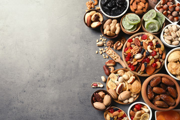 Fototapeta na wymiar Flat lay composition of different dried fruits and nuts on color background. Space for text