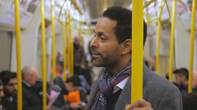 African businessman in a London underground train