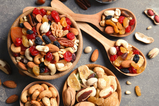 Flat lay composition of different dried fruits and nuts on color background