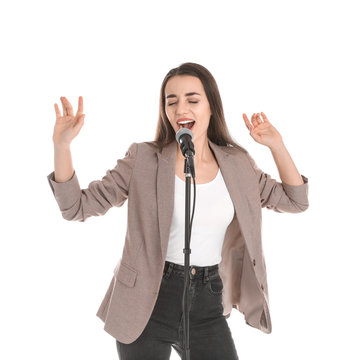 Young stylish woman singing in microphone on white background