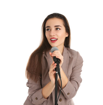 Young stylish woman in jacket posing with microphone on white background