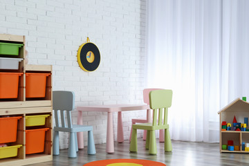 Modern child room interior with table and chairs