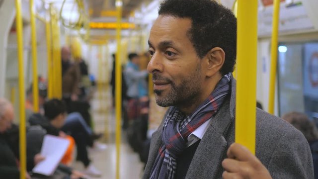 Black businessman in a London underground coach