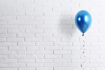 Bright balloon near brick wall, space for text. Party time