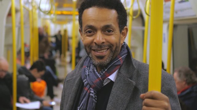 African businessman in a London underground train