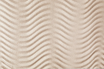 Zen garden pattern on sand as background, top view. Meditation and harmony