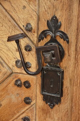 Ancient door handle on a wooden door