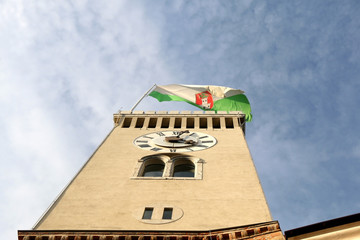 Historical watchtower on Ljubljana castle, landmark in Ljubljana, Slovenia. Flag of Ljubljana city on the top.