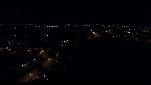 Flying At Night Over Neighborhood