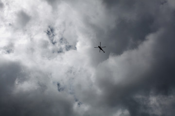 Helicopter against cloudy sky © lukszczepanski