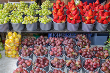 The market for fruits and vegetables grapes, plums and strawberries. South America, Quito, Ecuador.