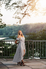 High School Senior Photo of Blonde Caucasian Girl Outdoors in Romper Dress