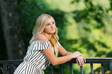 High School Senior Photo of Blonde Caucasian Girl Outdoors in Romper Dress