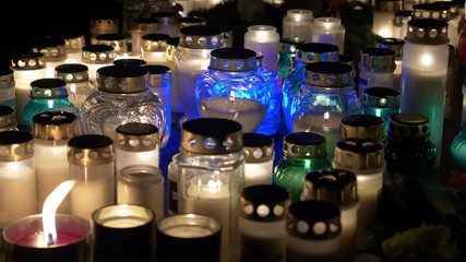 Bright lights of burning candles in the darkness 