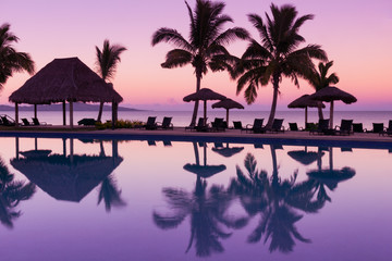 Pinkish purple sunrise colors reflecting in the water in Fiji