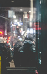 people walking in city at night