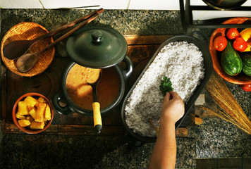 Finishing with a mint leaf on rice, brazilian dish typical of Brazilian cuisine
