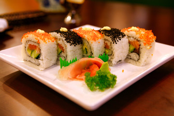 Uramaki rolls with tuna and salmon served on a white plate. Beijing, China. 