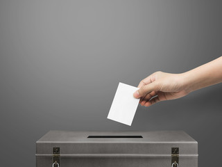 Hand holding ballot paper for election vote concept at Living Coral pantone background, clipping path Isolated.