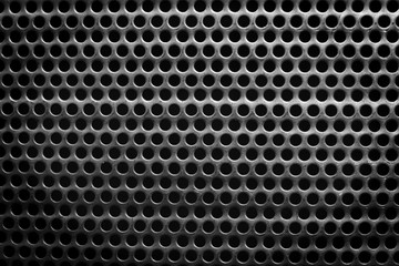black and white steel surface with little round holes