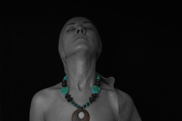 portrait of a woman wearing a turquoise necklace on black and white