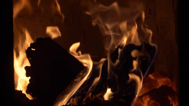 Throwing  firewood into a Tile Stove / Cockle