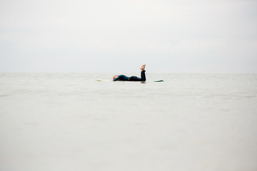 Female surfer resting in the ocean