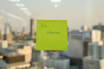 sticker note with job interview message for reminder