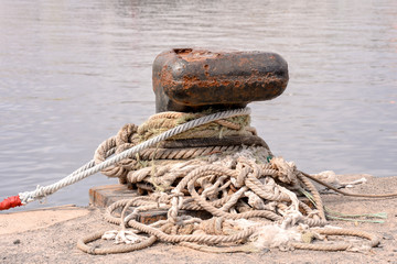 Rusty metal mooring bolard for big ship