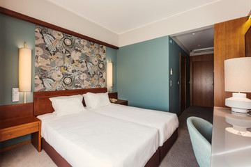 Small Hotel room interior with blue colours wall, wooden elements in design