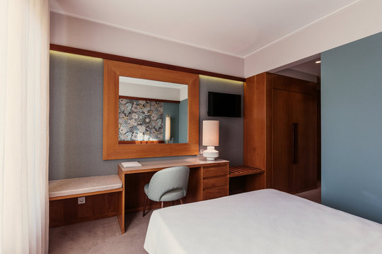 Small Hotel room interior with blue colours wall, wooden elements in design