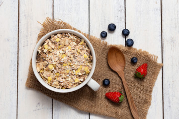 homemade Granola,yogurt and fresh blueberry with Strawberry In the cup on wooden background
