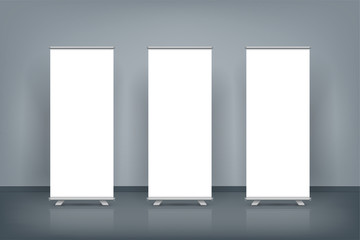 Three blank roll up banner posters display in dark blue wall, Mock up