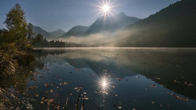 timelapse of morning fog at lake Schwansee in the Alg&radic;&sect;u Alps in Germany