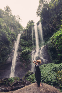 Young woman near jungle waterfall