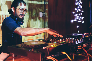 DJ man in night club on reggae party