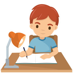 Cute boy writing his homework at night