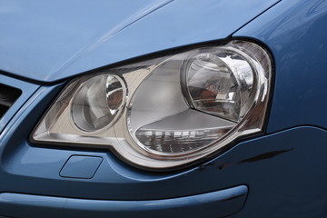 shiny headlight on a  white car