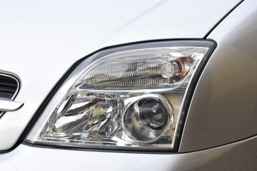shiny headlight on a  white car