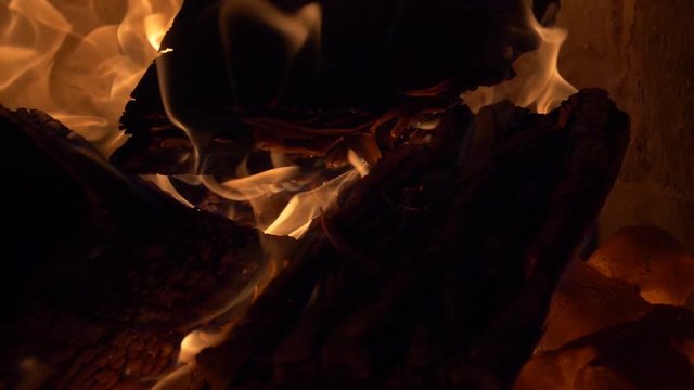 Firewood burning in 180 fps slow motion - tilt up