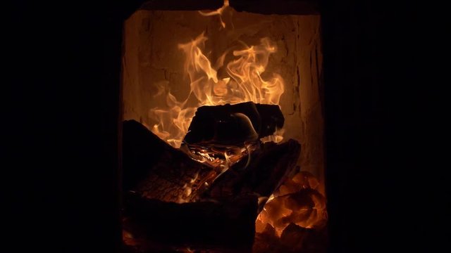 Firewood burning in tile stove / cockle 180 fps slow motion