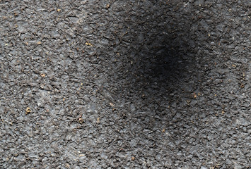 Closeup of asphalt ground of the road under sunlight with black shadow on it. The natural art background, template and other artwork use. 