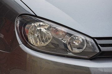 shiny headlight on a  white car