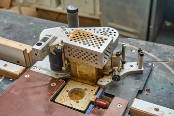 Edge banding machine in the workshop. Wooden furniture manufacturing process