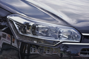  Car's exterior details. shiny headlights on a  gray car