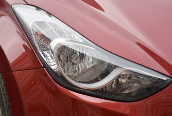  Car's exterior details. shiny headlights on a red car