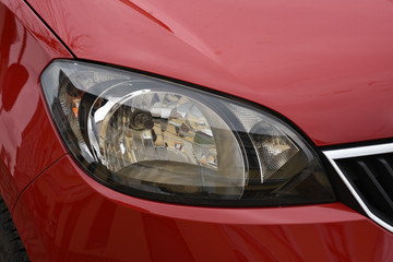 shiny headlights on a red  car