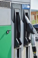 Man hand holding gasoline pump in a gas station