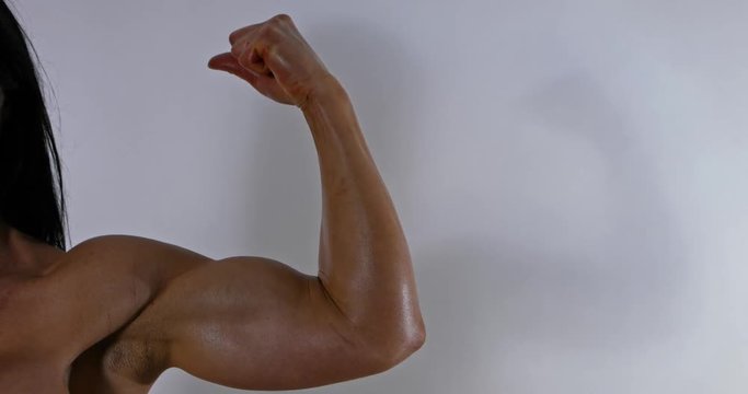 Strong woman showing her biceps